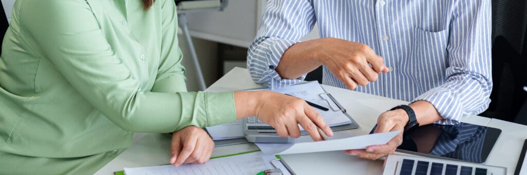 Adult Asian Business Professionals Hands Collaborating on ESG Reporting and Sustainable Finance Strategy Development for Corporate Responsibility