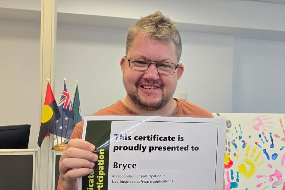 Person holding a certificate in a training workspace, representing a digital literacy skills framework that supports practical digital skills.